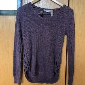 Plum colored sweater with cut/cross bottom sides.